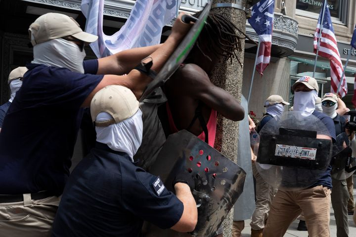 FILE - Members of a group bearing insignias of the white supremacist Patriot Front shove Charles Murrell with metal shields during a march through Boston on July 2, 2022. The Black musician who says members of the white nationalist hate group punched, kicked and beat him with metal shields during a march through Boston in 2022 sued the organization on Tuesday, Aug. 8, 2023. (AP Photo/Michael Dwyer, File)