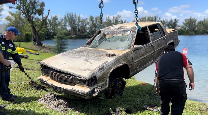 Miami-Dade County authorities remove one of 32 cars found submerged in a lake in Doral, Florida, on Aug. 8, 2023. 