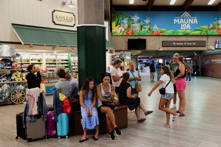 People are seen at the airport after wildfires driven by high winds which were believed to have destroyed a large part of the historic town of Lahaina, in Kahului, Hawaii, U.S. August 9, 2023. REUTERS/Marco Garcia