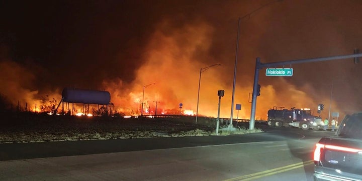 Fire and smoke fill the sky from wildfires Tuesday at the intersection of Hokiokio Place and Lahaina Bypass on Maui.