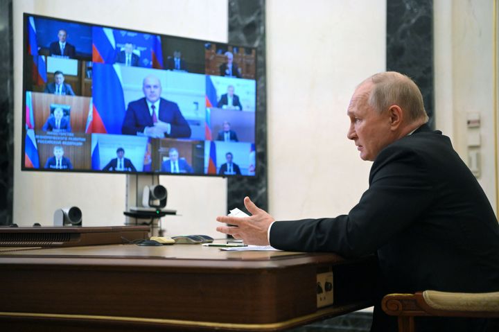Vladimir Putin chairing a meeting with members of the Russian government.