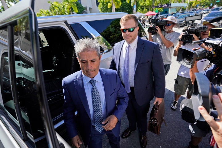Carlos De Oliveira, center, an employee of Donald Trump's Mar-a-Lago estate, arrives for a court appearance with attorney John Irving, at the James Lawrence King Federal Justice Building, July 31, 2023, in Miami.