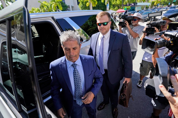 Carlos De Oliveira, center, an employee of Donald Trump's Mar-a-Lago estate, arrives for a court appearance with attorney John Irving, at the James Lawrence King Federal Justice Building, July 31, 2023, in Miami. 