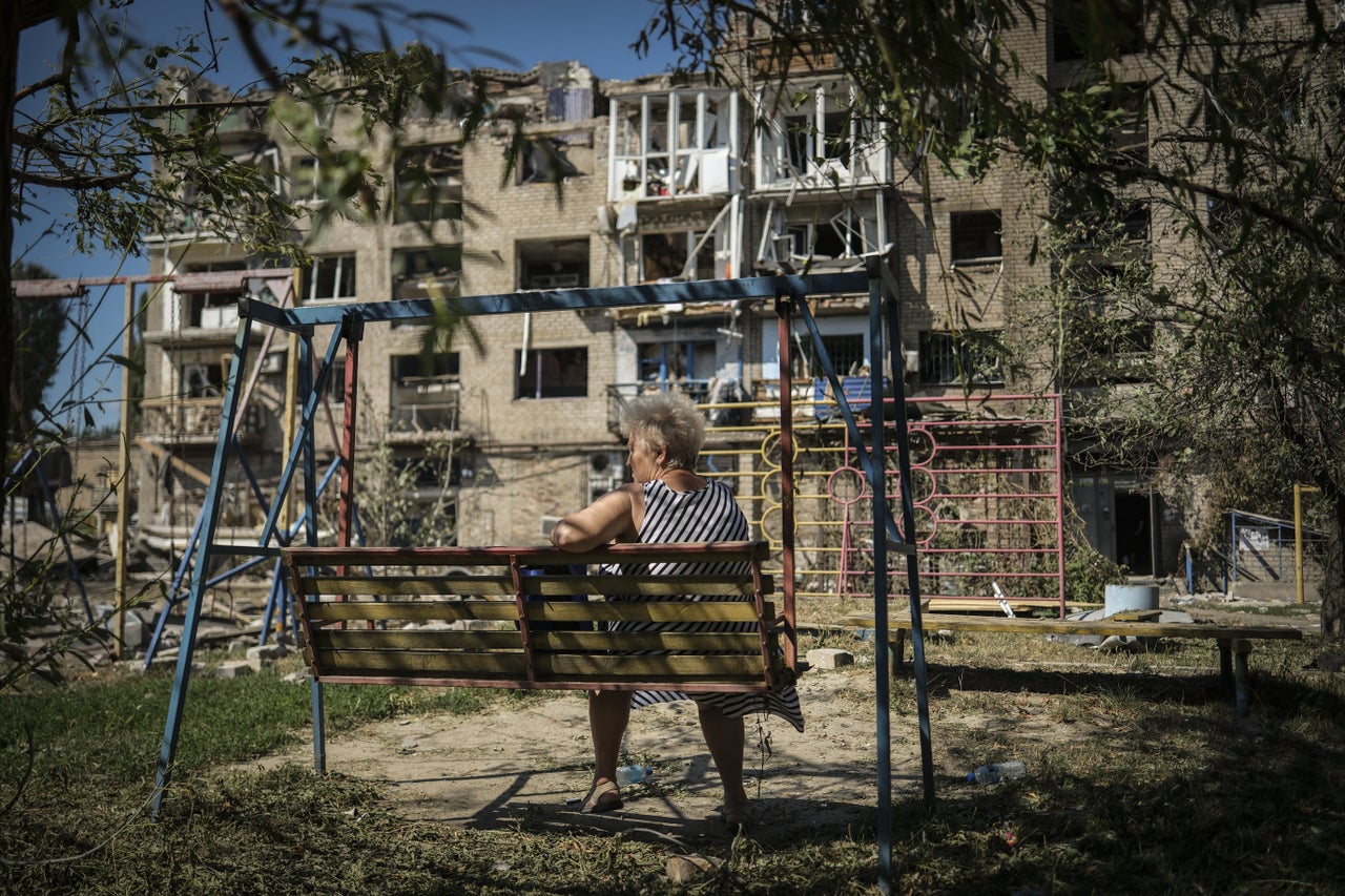 A resident sits outside a damaged building after a Russian missile attack in Pokrovsk, Donetsk Oblast, Ukraine on August 9. Ukrainian Interior Minister Igor Klimenko stated that seven people were killed in an overnight missile strike by the Russian forces on a city in Ukraine's eastern region of Donetsk.