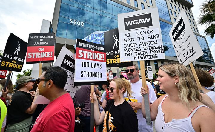 Members of the Writers Guild of America and the Screen Actors Guild-American Federation of Television and Radio Artists walk the picket line outside of Netflix in Hollywood, California, on Aug. 9, 2023. 