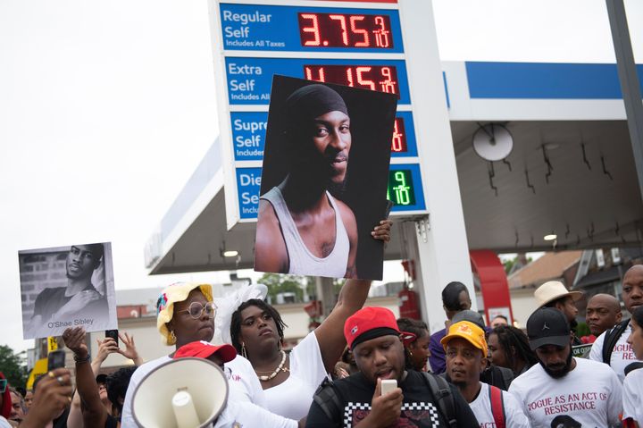 People gather at a gas station during a vigil to memorialize O'Shae Sibley on Friday, Aug. 4, 2023.