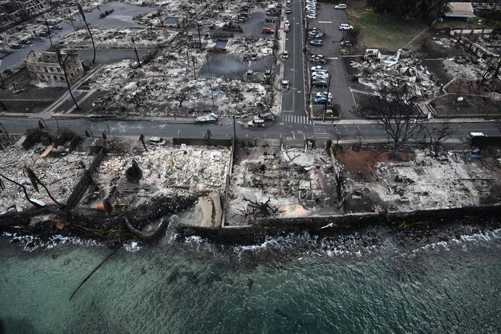 An aerial image taken on August 10, 2023 shows destroyed homes and buildings burned to the ground in Lahaina along the Pacific Ocean in the aftermath of wildfires in western Maui, Hawaii. A terrifying wildfire that left a historic Hawaiian town in charred ruins has killed at least 55 people, authorities said on August 10, making it one of the deadliest disasters in the US state's history. (Photo by Patrick T. Fallon / AFP) (Photo by PATRICK T. FALLON/AFP via Getty Images)
