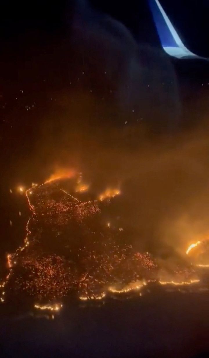 An aerial view of flames rising following wildfires, over Lahaina, Maui, Hawaii.