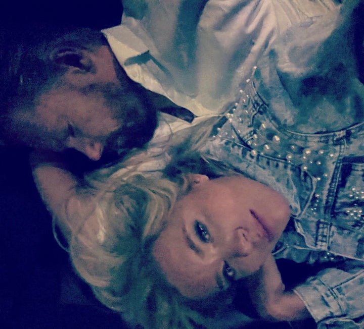 Cindy Curler and her husband Bob Curler lay on a couch in the garage office of the limousine after their wedding in Lahaina, Hawaii on Wednesday. The Pittsburgh couple were unable to get back to their Lahaina hotel Tuesday on their wedding night as wildfires swallowed the town. Their driver was forced to take them to the garage where he parks his limousine.