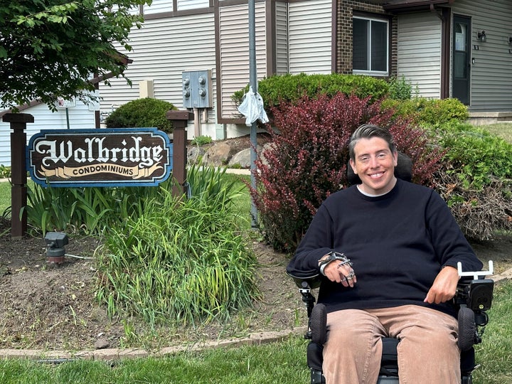 Wisconsin state Rep. Jimmy Anderson poses, Thursday, Aug. 10, 2023, in Madison, Wis., outside of a condominium complex that is disconnected from the rest of his legislative district. A lawsuit contends that such disconnected sections of land violate the state constitution and that the current districts should be redrawn before the 2024 election. 