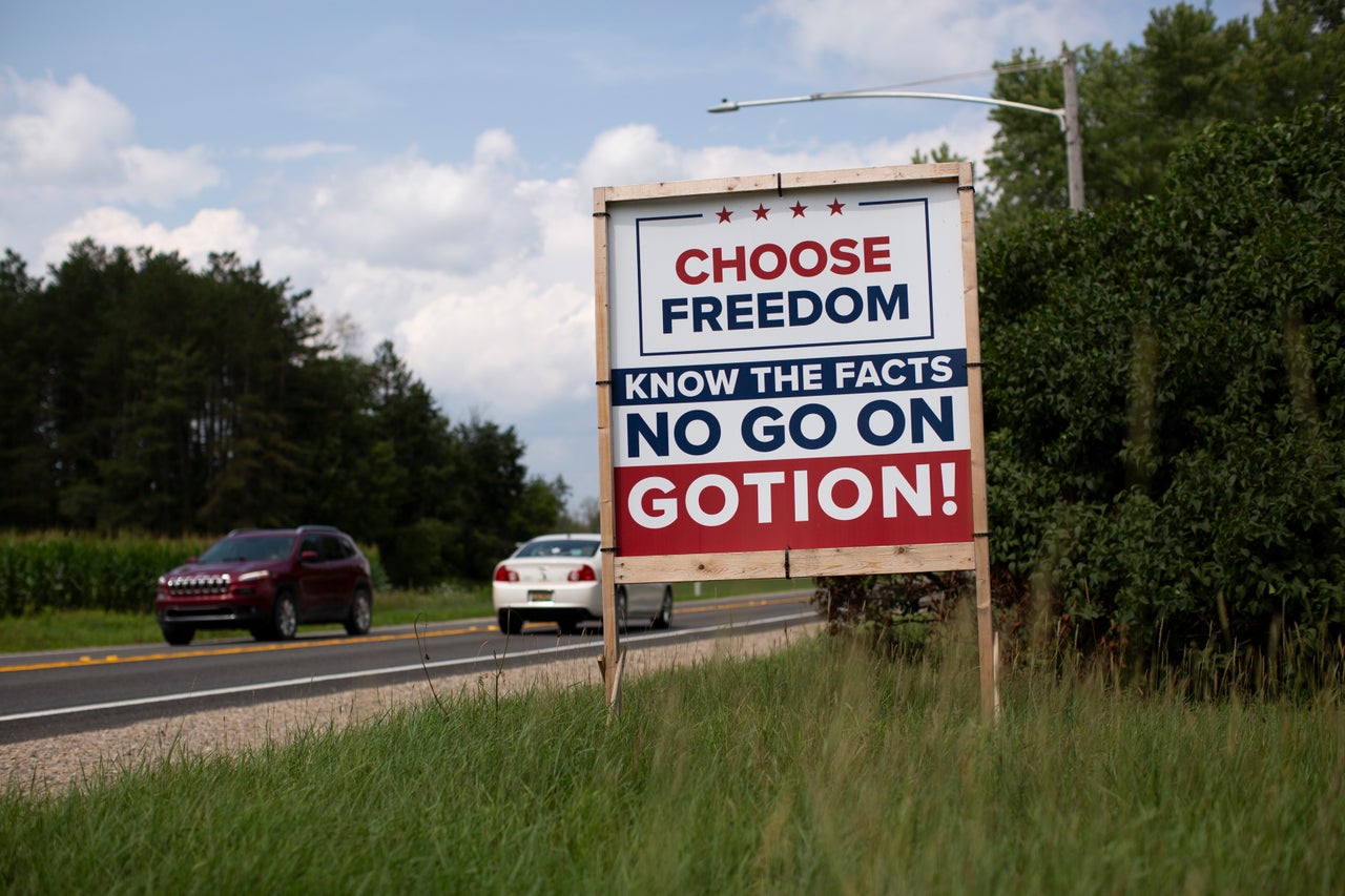 Signs along one of the main roads in Green Township urge locals to protest plans for a planned electric vehicle battery factory there. It would be run by Gotion, the U.S.-based subsidiary of a Chinese company.