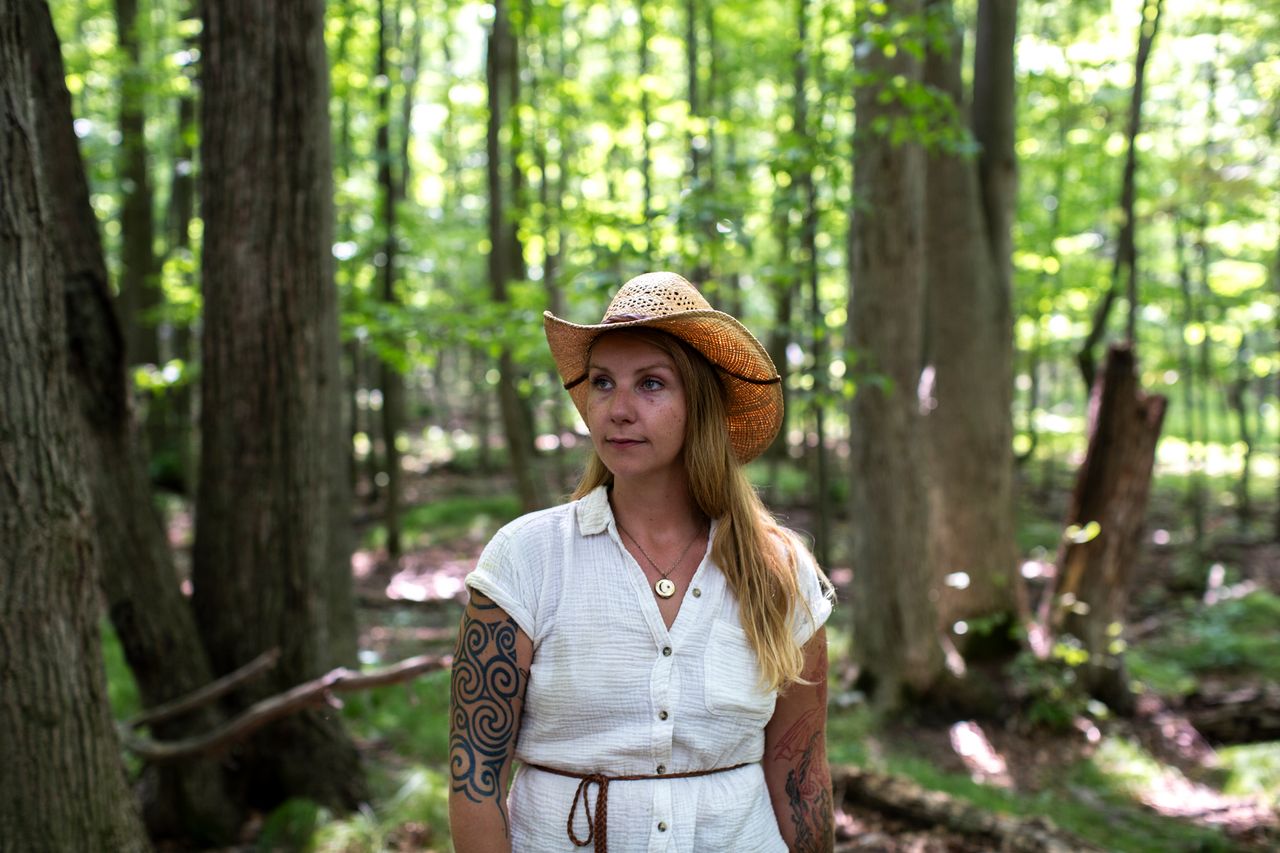 Marjorie Steele, an anti-Gotion activist who lives in the area, stands near some of the old-growth trees on her family's land. She thinks the factory is a threat to the area's ecosystem.