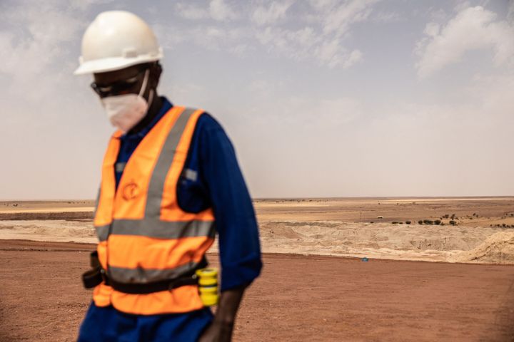 A mineworker walks on the residual dump at a mine near Arlit, Niger, on March 8.