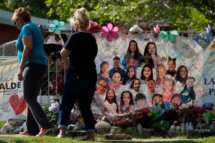 Visitors walk past a makeshift memorial at Robb Elementary School, Tuesday, Sept. 6, 2022, in Uvalde, Texas.