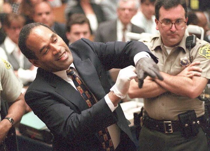 O.J. Simpson, on trial for double murder in 1995, demonstrates that a bloody glove found on his property does not fit during his highly publicized trial.