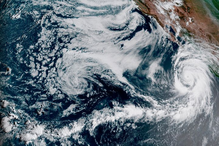 This Friday, Aug. 18, 2023, 1:10 p.m. EDT satellite image provided by the National Oceanic and Atmospheric Administration shows Hurricane Hilary, right, off Mexico’s Pacific coast.
