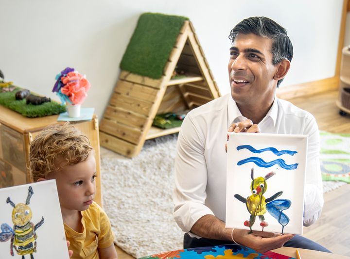 Rishi Sunak holds an image of a bee he created during a visit to the Busy Bees nursery in Harrogate, North Yorkshire (Photo by Danny Lawson - WPA Pool/Getty Images)