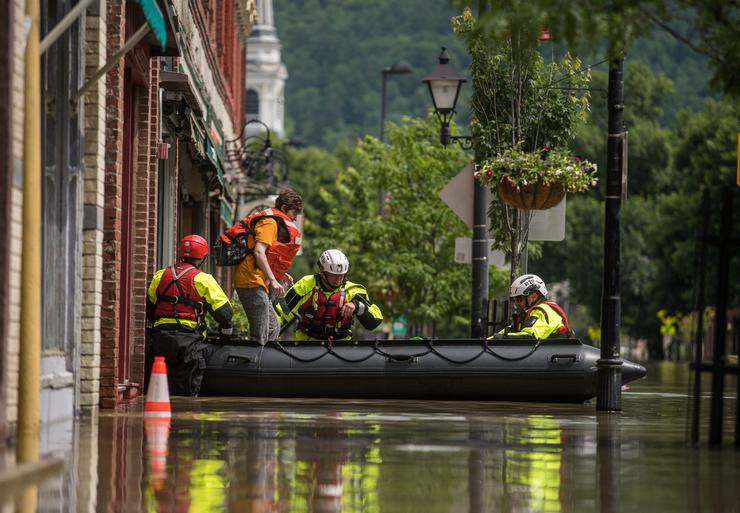 Members of the Colchester Technical Rescue team respond to a call to evacuate two adults and an infant from their downtown Montpelier, Vermont, apartment on July 11, 2023, after heavy rains caused flooding across the state. 