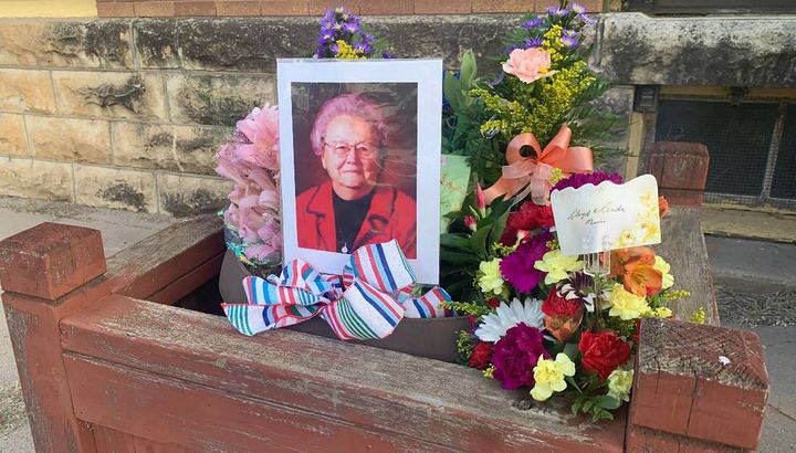 Residents left flowers outside the Marion County Record in central Kansas in remembrance of co-owner Joan Meyer, who died a day after police raided the newsroom.