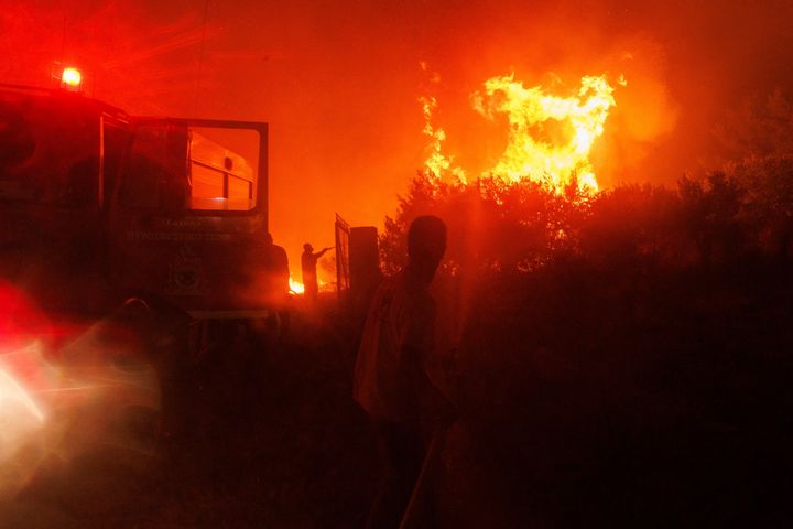 Firefighters try to extinguish the flames in a forest in Avantas village, near Alexandroupolis town, in the northeastern Evros region, Greece, on Aug. 21, 2023. 