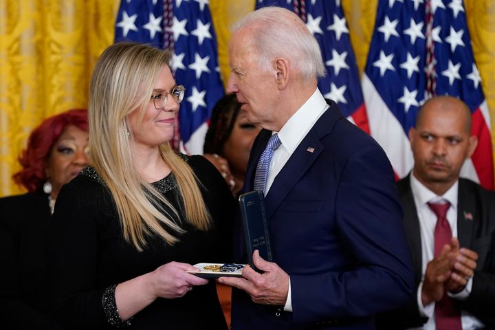 President Joe Biden presents the Presidential Citizens Medal posthumously to Washington Metropolitan Police Officer Jeffrey Smith, as his widow, Erin Smith, accepts the medal. The ceremony was held on the second anniversary of the Jan. 6, 2021, assault on the Capitol.