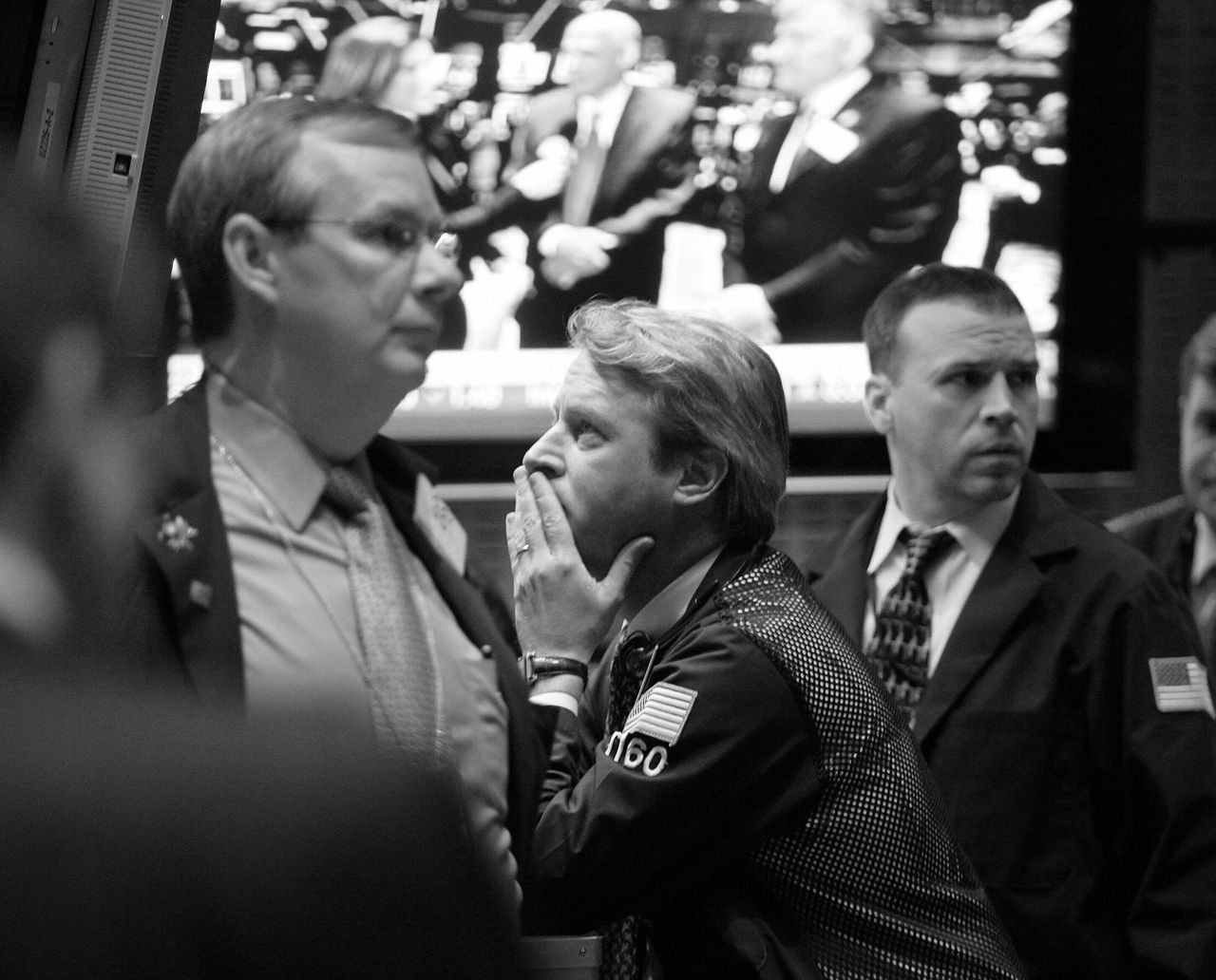 Traders watch the morning board as Secretary of the Treasury Henry Paulson visits the New York Stock Exchange trading floor with NYSE Euronext CEO Duncan L. Niederauer on Jan. 8, 2008.