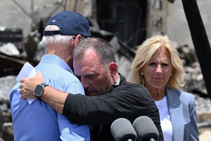 President Joe Biden is embraced by Hawaii Governor Josh Green after delivering remarks as he visits an area devastated by wildfires in Lahaina, Hawaii on Aug. 21.