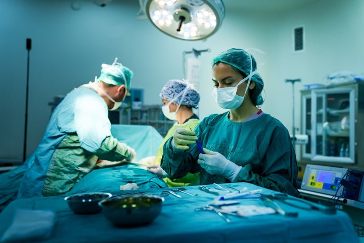 Sterile table holding surgical equipment in the operating room