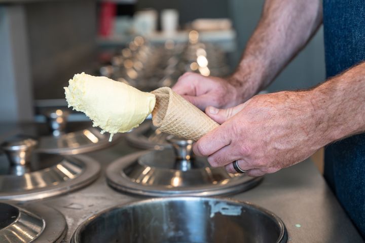 Artisanal gelato is traditionally stored in stainless steel containers, often with the lid on top.