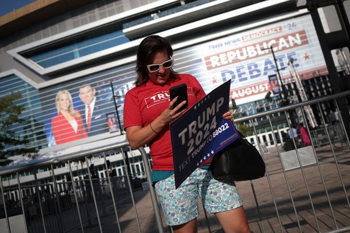 A supporter of Republican presidential candidate Donald Trump waits for the start of the GOP primary debate Wednesday in Milwaukee, Wisconsin.