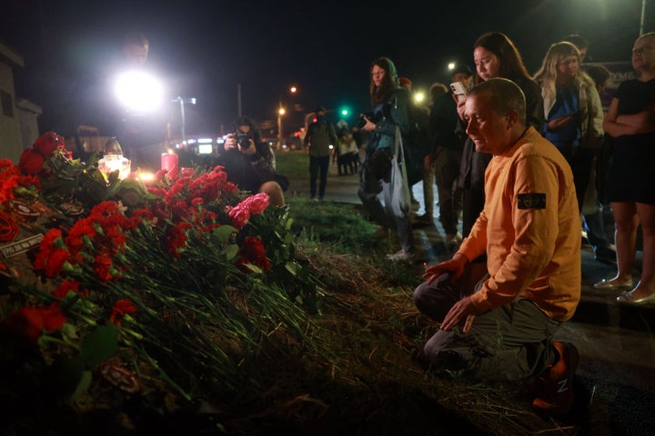 People pay tribute to Yevgeny Prigozhin at the makeshift memorial in front of the "PMC Wagner Centre" in Saint Petersburg, early on August 24, 2023.