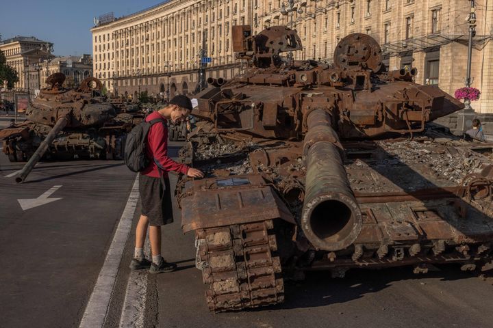A man looks at a destroyed Russian tank on display in Khreshchatyk Street on Ukraine's Independence Day in Kyiv, on August 24, 2023.