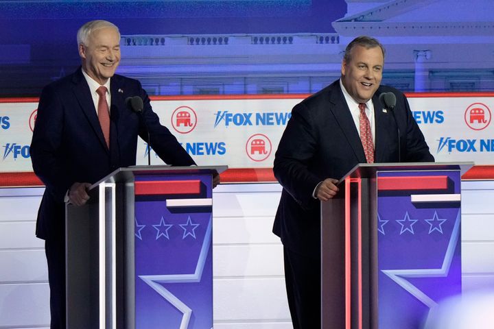 Former New Jersey Gov. Chris Christie answers a question alongside former Arkansas Gov. Asa Hutchinson during the Republican presidential primary debate hosted by Fox News on Aug. 23, 2023, in Milwaukee.