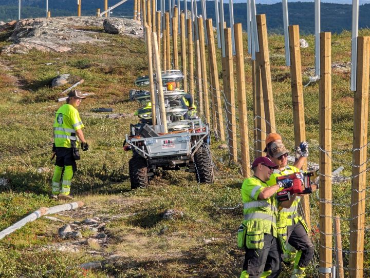People work to build a new fence along the border with Russia next to Storskog, Norway on Wednesday.