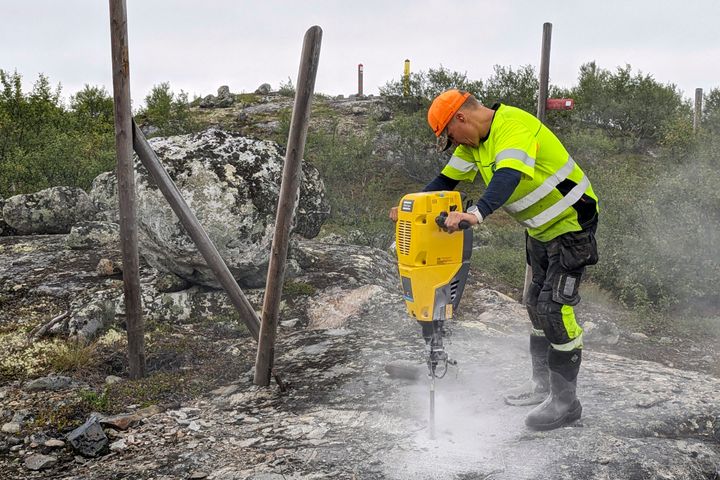 A man helps build a new fence along Norway's border with Russia on Wednesday. Norway is re-building a section of fence in the Arctic along its border with Russia to contain wandering reindeer, Norwegian officials said Thursday, adding 42 animals have crossed into its eastern neighbor in a costly stroll this year.