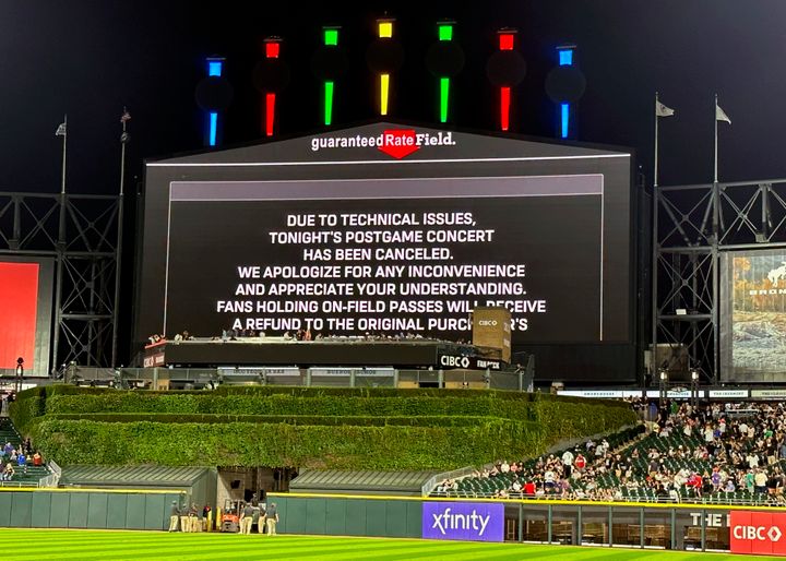 A message on the main scoreboard at Guaranteed Rate Field announces the cancellation of a 90s concert that was set to take place after the Chicago White Sox and Oakland Athletics game on Friday.