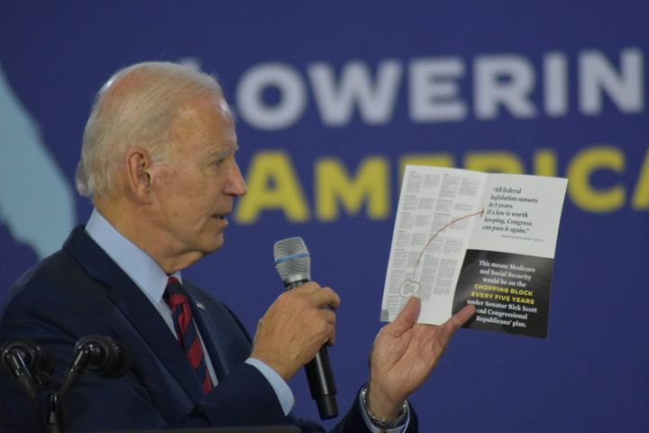 President Joe Biden holds up a pamphlet as he delivers remarks on Medicare and lowering prescription drug costs in Hallandale Beach, Florida, on Nov. 1, 2022.
