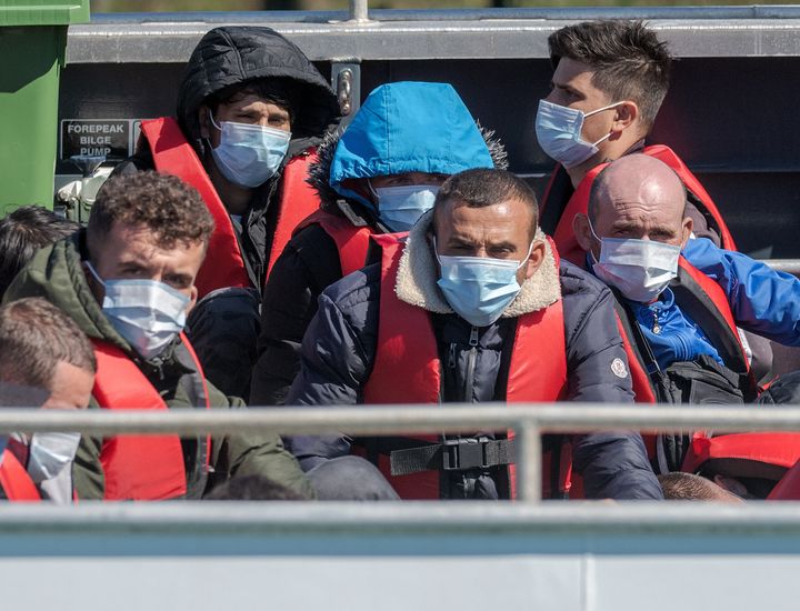 Migrants are escorted back to Dover after being picked up in the English Channel.