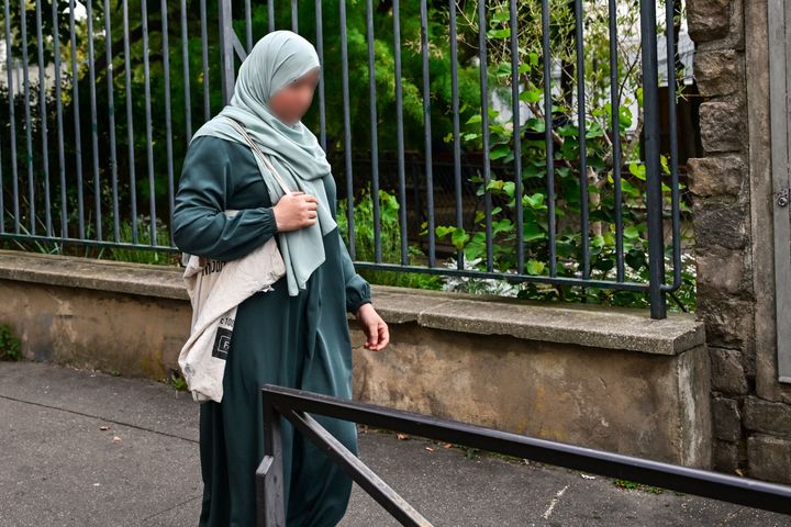 A photograph taken Monday shows a woman wearing an abaya walking in the streets of Paris. France will ban students from wearing abayas in state-run schools, France's education minister said Sunday.
