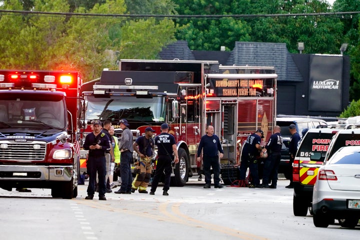 Fire and rescue personnel work in the area where a medical rescue helicopter crashed in Pompano Beach.