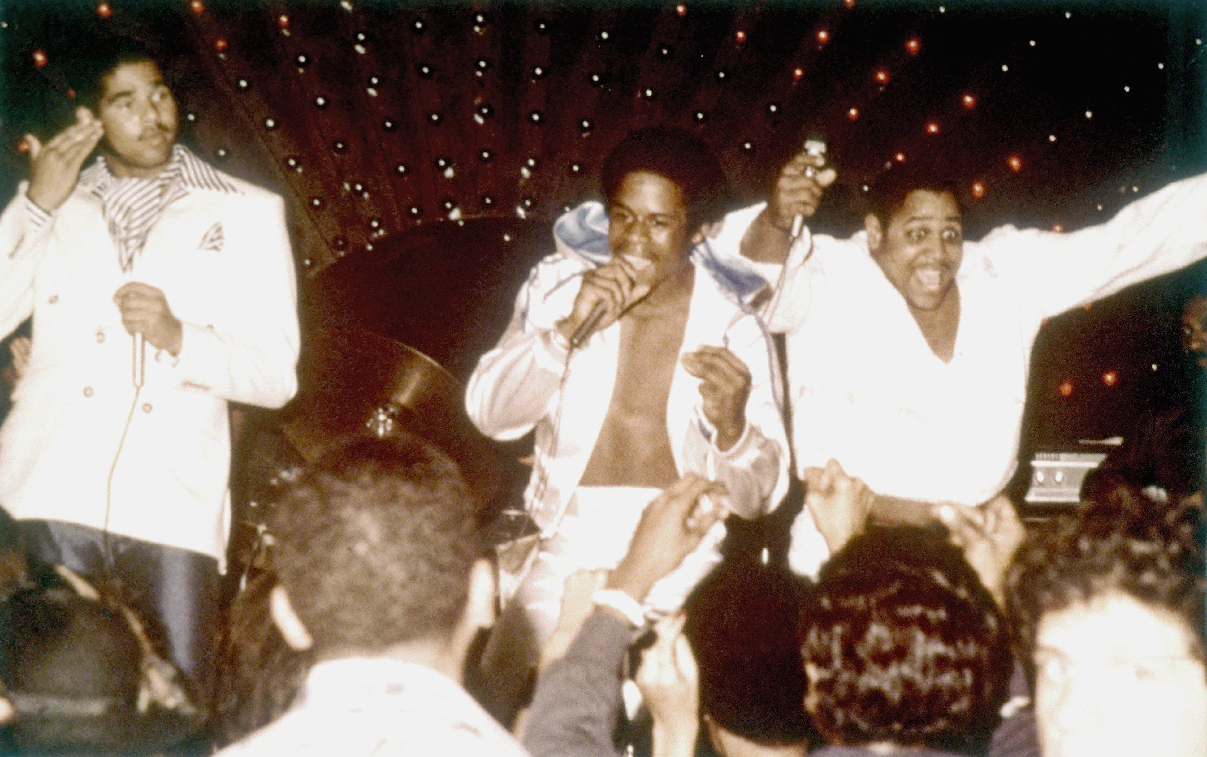 Sugar Hill Gang (L-R Michael "Wonder Mike" Wright, Guy "Master Gee' O'Brian and Henry "Big Bank" Jackson) perform on stage circa late 1970's in New York.