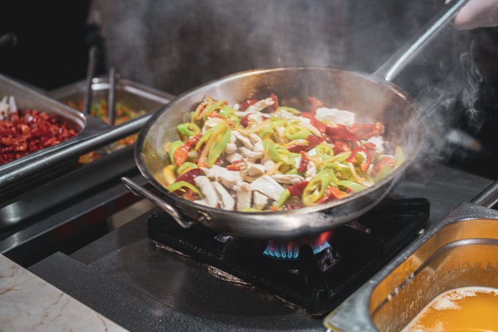 Chef tossing flaming vegetable