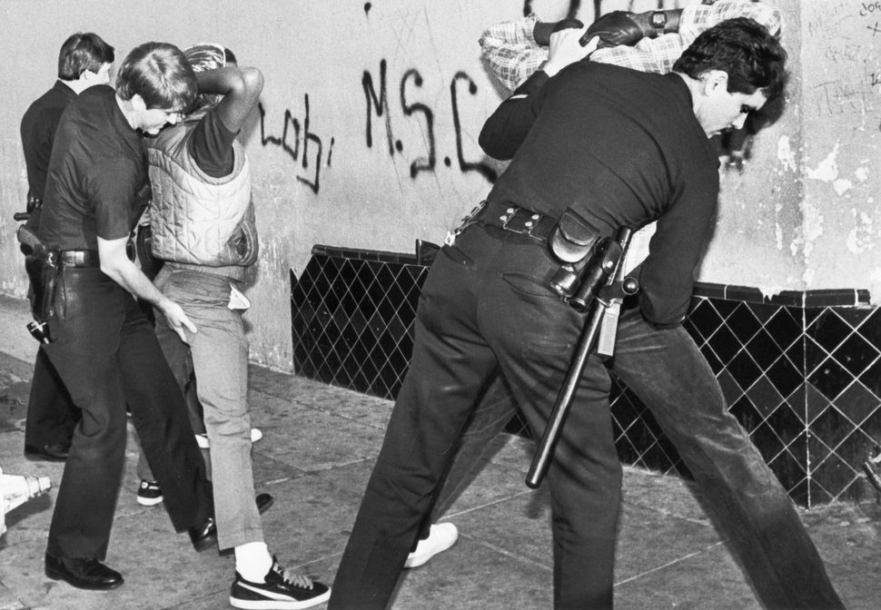 Los Angeles police search suspected members of the Rolling 60s gang for weapons and drugs during a sweep in south Los Angeles. The South L.A. area accounts for the largest number of street gangs in the nation, about 150 groups of mostly Black and Hispanic youths. Credit: Bettman/Getty Images
