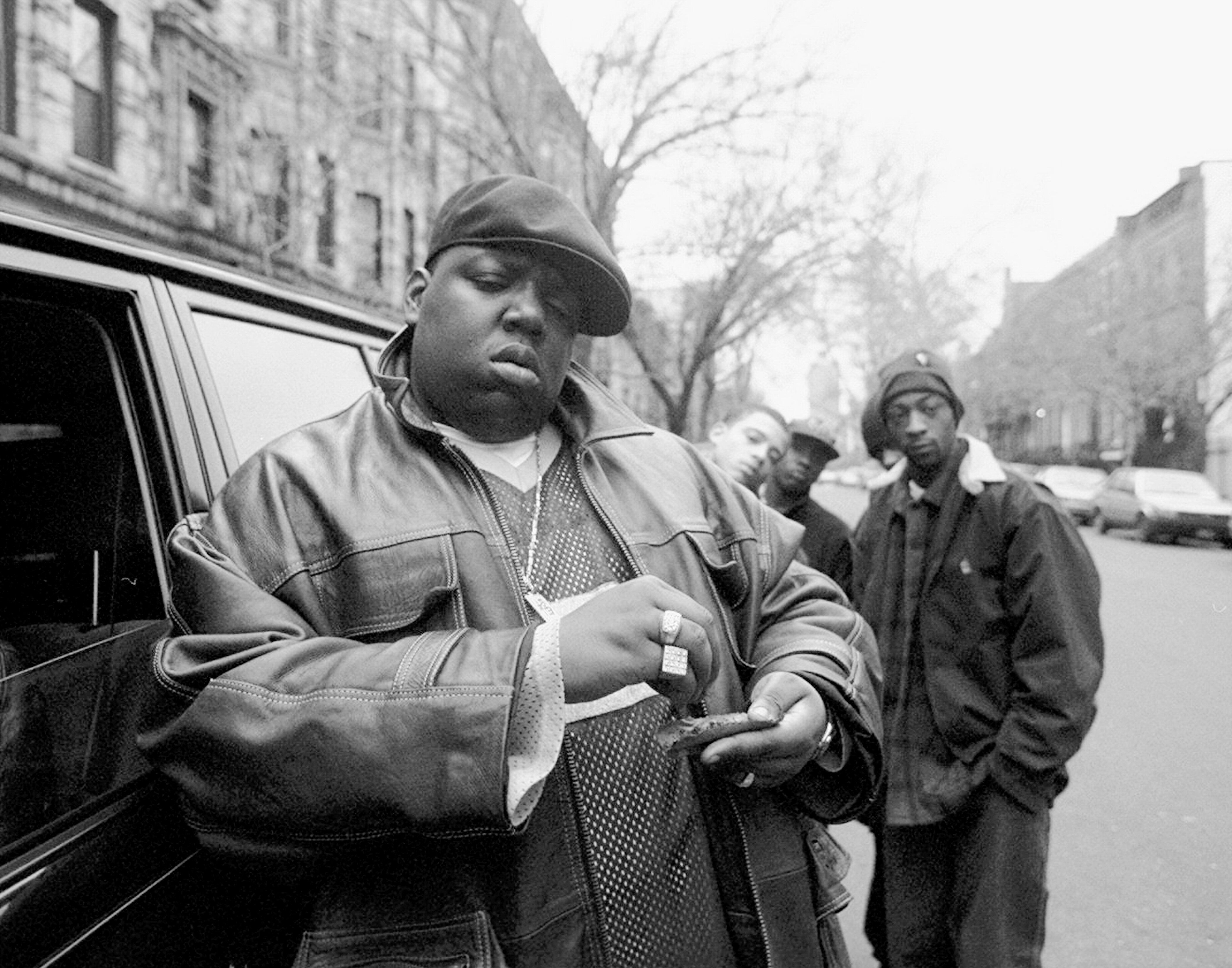 American rapper Notorious B.I.G., also known as Biggie Smalls, whose legal name was Chris Wallace, rolls a cigar-looking item outside his mother's house in Brooklyn, New York, Jan. 18, 1995.