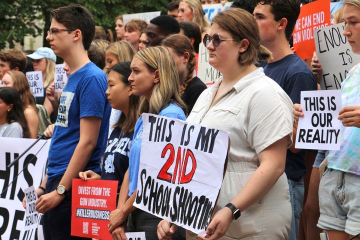 Students hold signs during a gun safety rally on Wednesday following a fatal shooting earlier in the week on the University of North Carolina at Chapel Hill campus.