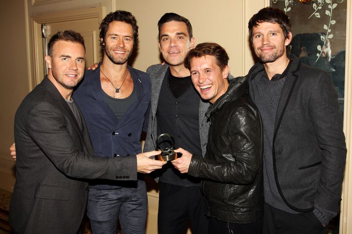 Robbie (centre) with his former Take That bandmates Gary Barlow, Howard Donald, Mark Owen and Jason Orange in 2010. 