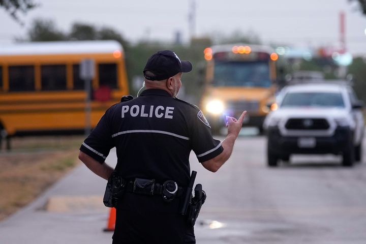 Southside Independent School District police officer Ruben Cardenas keeps watch as students arrive at Freedom Elementary School, on Aug. 23, 2023, in San Antonio.