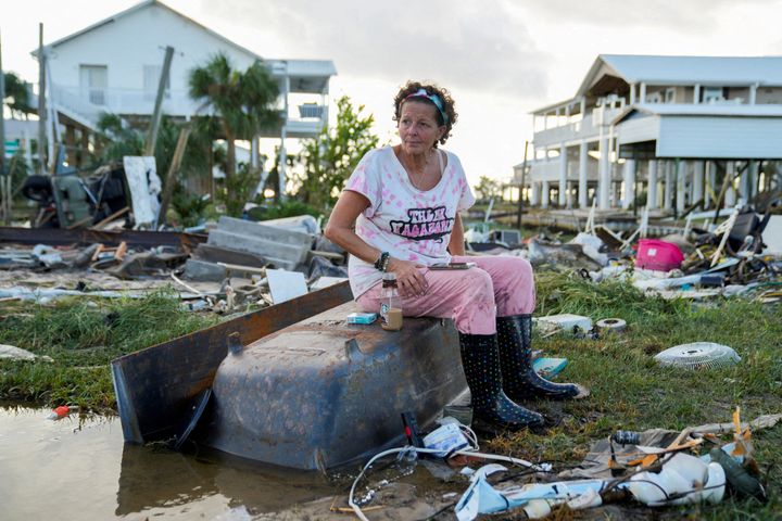 Jewell Baggett, 51, sits on a bathtub amid the wreckage from Hurricane Idalia in Horseshoe Beach, Florida, on Wednesday. 
