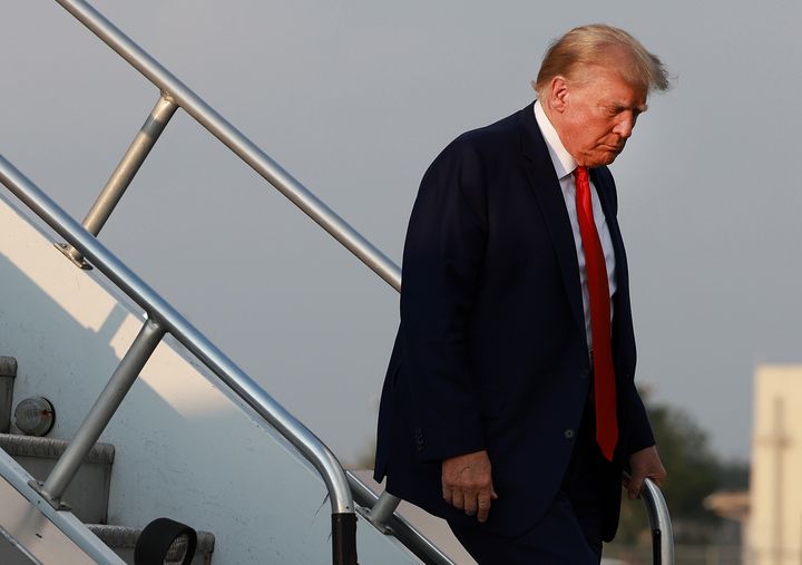 Former President Donald Trump arrives at an Atlanta airport on Aug. 24 before surrendering at a Georgia jail.