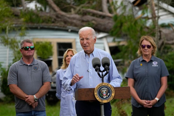 President Joe Biden speaks in front of a home damaged by fallen trees and debris following a survey of damage caused by Hurricane Idalia, Saturday, Sept. 2, 2023, in Live Oak, Fla. (AP Photo/Julio Cortez)
